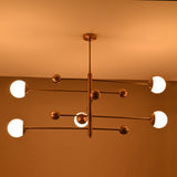 Modern bedroom globe ceiling light with five lights arranged on a clean architectural brass frame