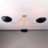 Modern sculptural chandelier with three black bowl shades and brass arms, designed for wide ceiling coverage.