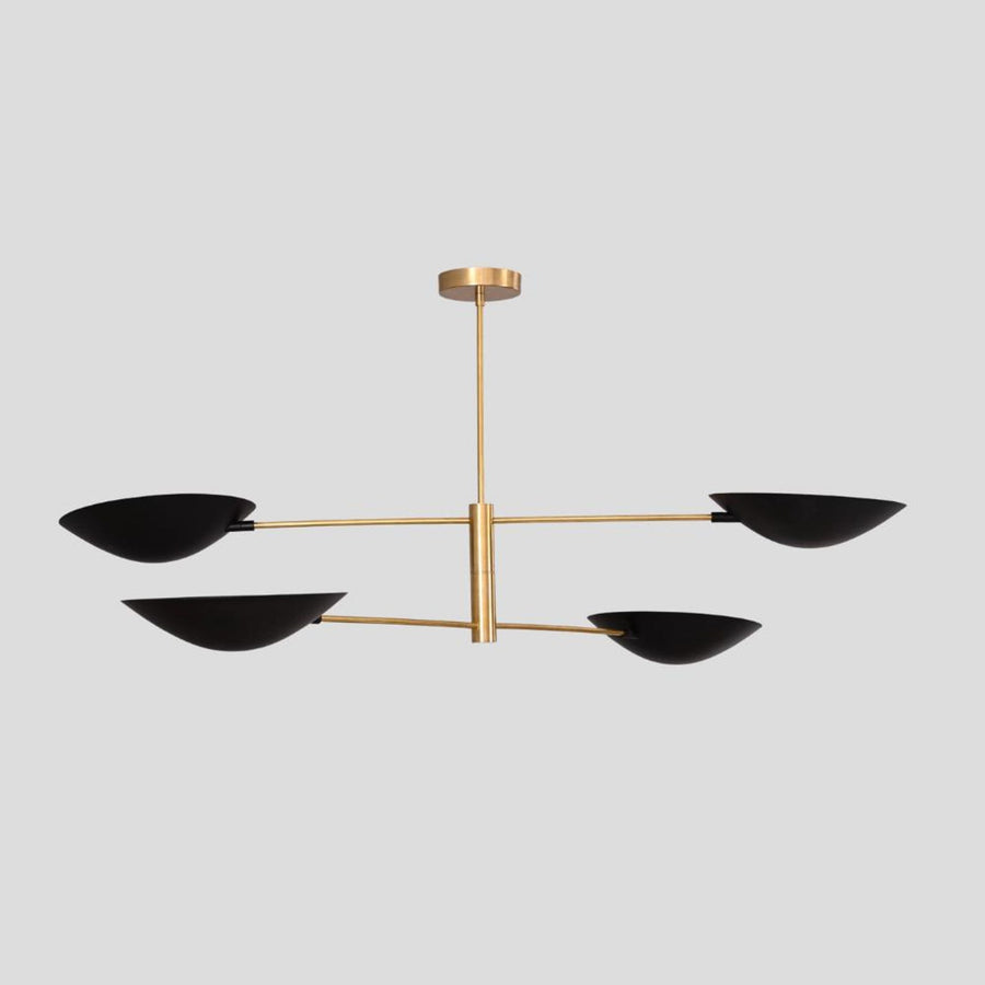 Modern brass chandelier with four matte black bowl-shaped shades, minimalist pendant lighting for dining rooms and living spaces.