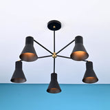 Angled view of 5 cone brass chandelier showing warm glow and tapered cone metal shades