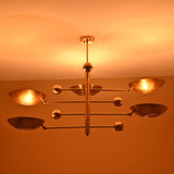 Modern celestial brass chandelier with five indirect lights and brushed finish, mounted on ceiling.