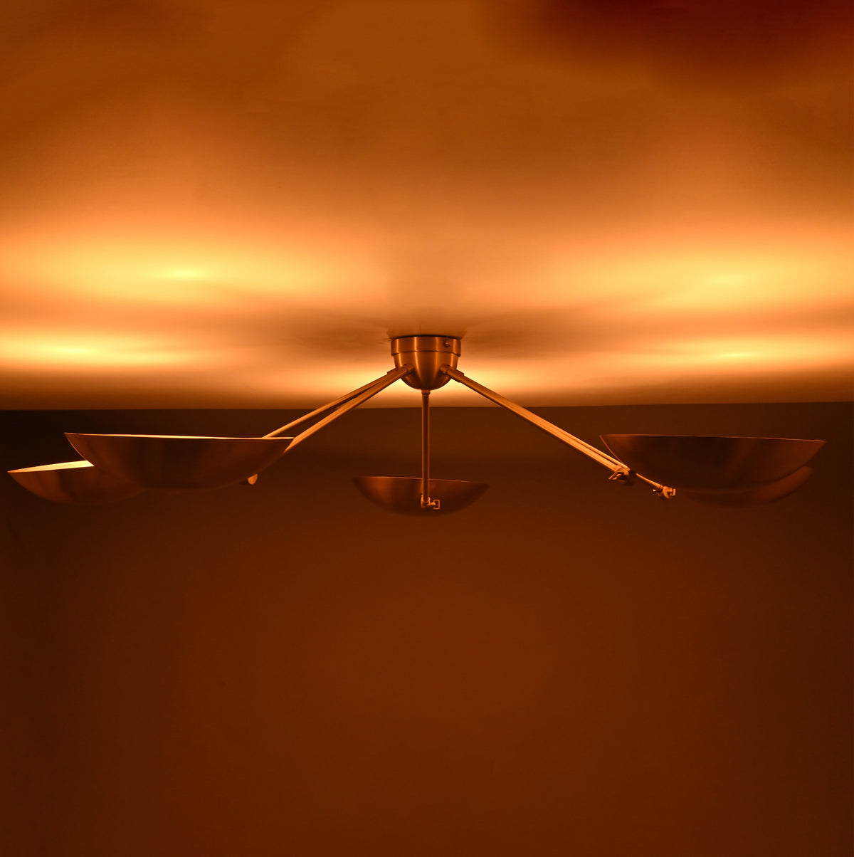 Installed look of modern brass bowl ceiling light enhancing contemporary interiors with warm ambient illumination.