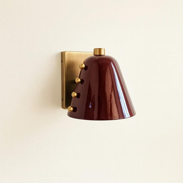 Modern brass cone wall sconce with burgundy metal shade and brushed brass backplate