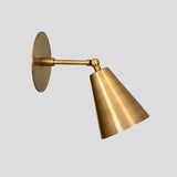 Modern brass cone wall sconce, handmade adjustable lighting fixture with minimalist industrial design.