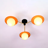 Modern brass disc ceiling light with three opal glass globes providing warm ambient illumination.