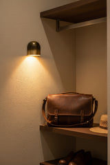 Modern dome wall light with architectural rounded shape and focused warm illumination below