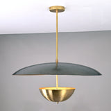 Front view of modern brass dual-shade pendant featuring a wide dome and inner brass bowl in a sculptural contemporary design.