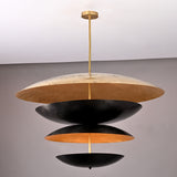 Modern sculptural brass chandelier featuring stacked black and gold discs crafted in a unique layered floating design.