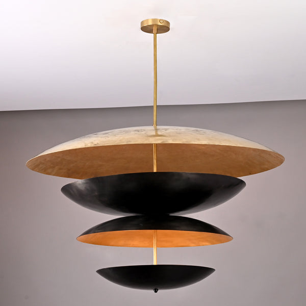 Modern sculptural brass chandelier featuring stacked black and gold discs crafted in a unique layered floating design.