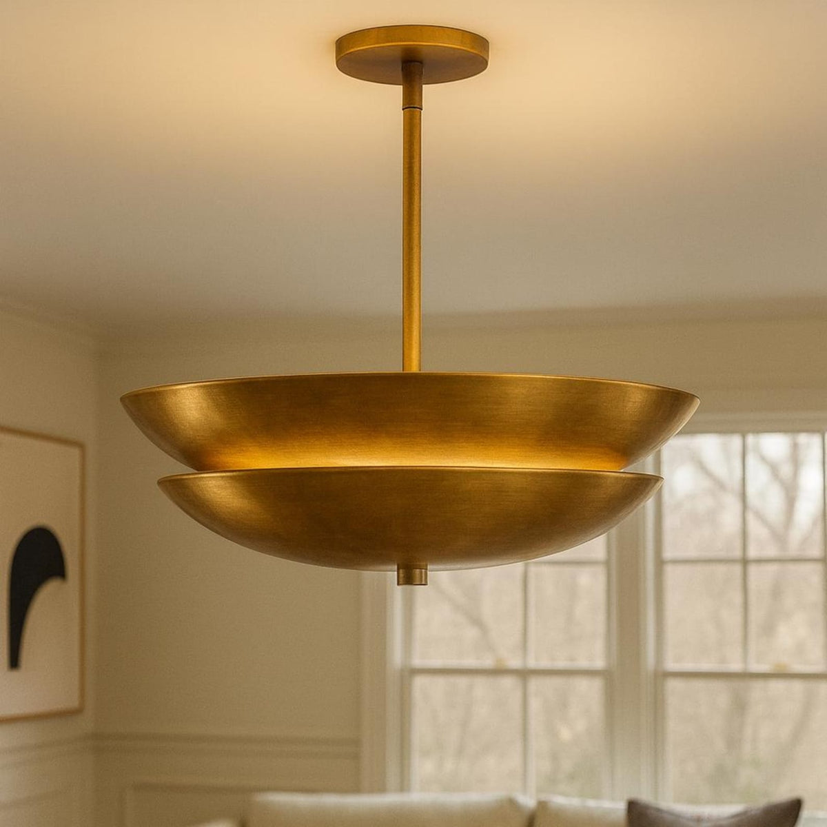 Modern solid brass layered disc pendant chandelier suspended from ceiling in warm brushed finish