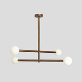Modern brass 4-light linear chandelier with frosted glass globes, handmade by Brass Leaf Studio.