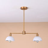 Modern two-light brass pendant with white domed shades and sleek minimalist design