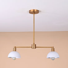 Modern two-light brass pendant with white domed shades and sleek minimalist design