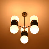 Modern ceiling chandelier with six opal glass globes arranged in a balanced sculptural form