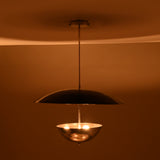 Modern chrome brass chandelier showcasing warm lighting effect with reflective polished surfaces