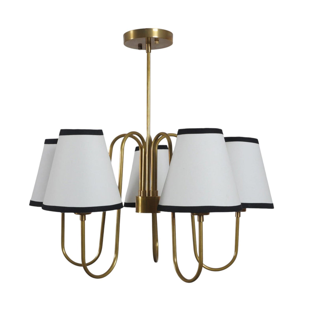 Modern classic brass chandelier featuring white conical fabric shades and elegant curved brass arms