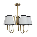 Modern classic brass chandelier featuring white conical fabric shades and elegant curved brass arms