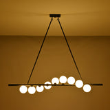 Modern dining room globe chandelier suspended above a wooden table with soft warm lighting and elegant décor