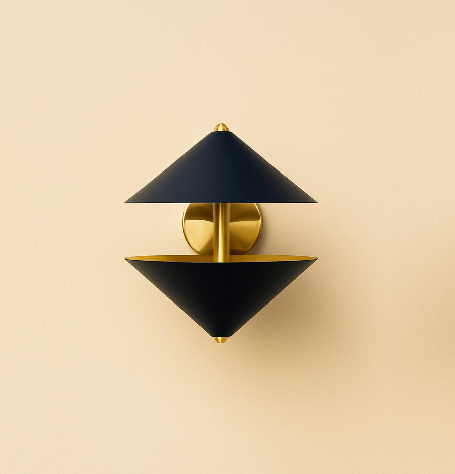 Front view of modern double cone brass wall sconce with matte black shades and brushed brass backplate, luxury industrial wall lighting fixture.
