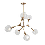 Modern 6-light brass chandelier featuring faceted glass globes and sleek molecular arm design for luxury interiors