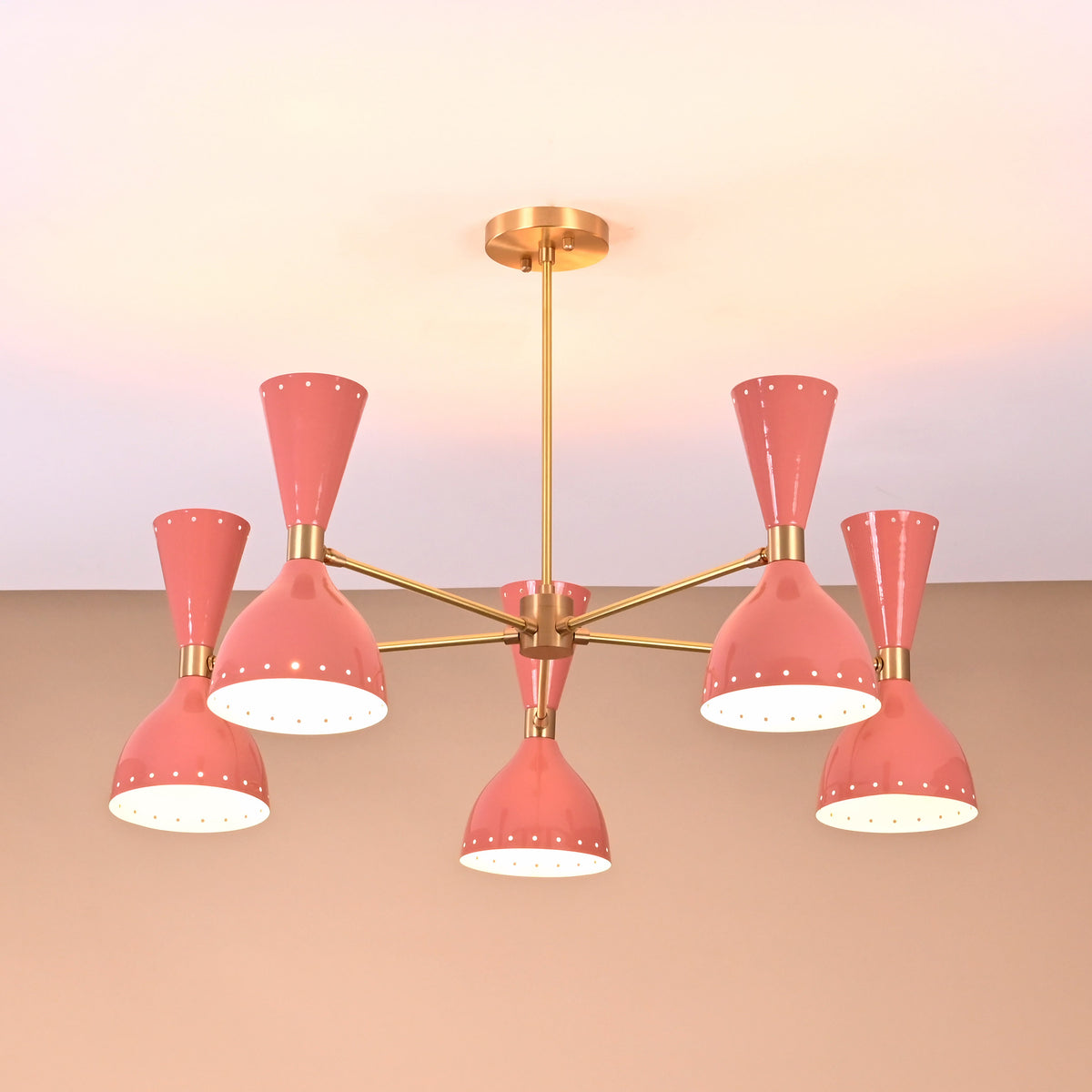 Ceiling-mounted peach double cone light fixture in brass finish for modern interiors