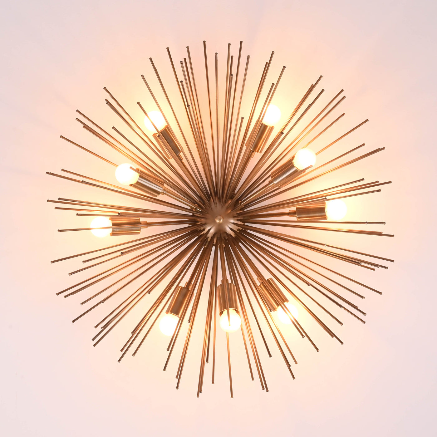 Top-down view of modern brass sputnik chandelier with evenly spaced light bulbs