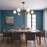 Monaco 6-light glass globe chandelier with copper patina brass arms and warm glowing white glass globes