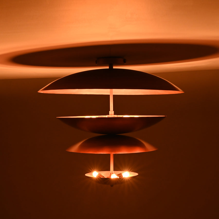 Front view of a 24x21 inch handmade multi-tier brass flushmount chandelier featuring sculpted bowl-shaped shades in a copper finish by Brass Leaf Studio.