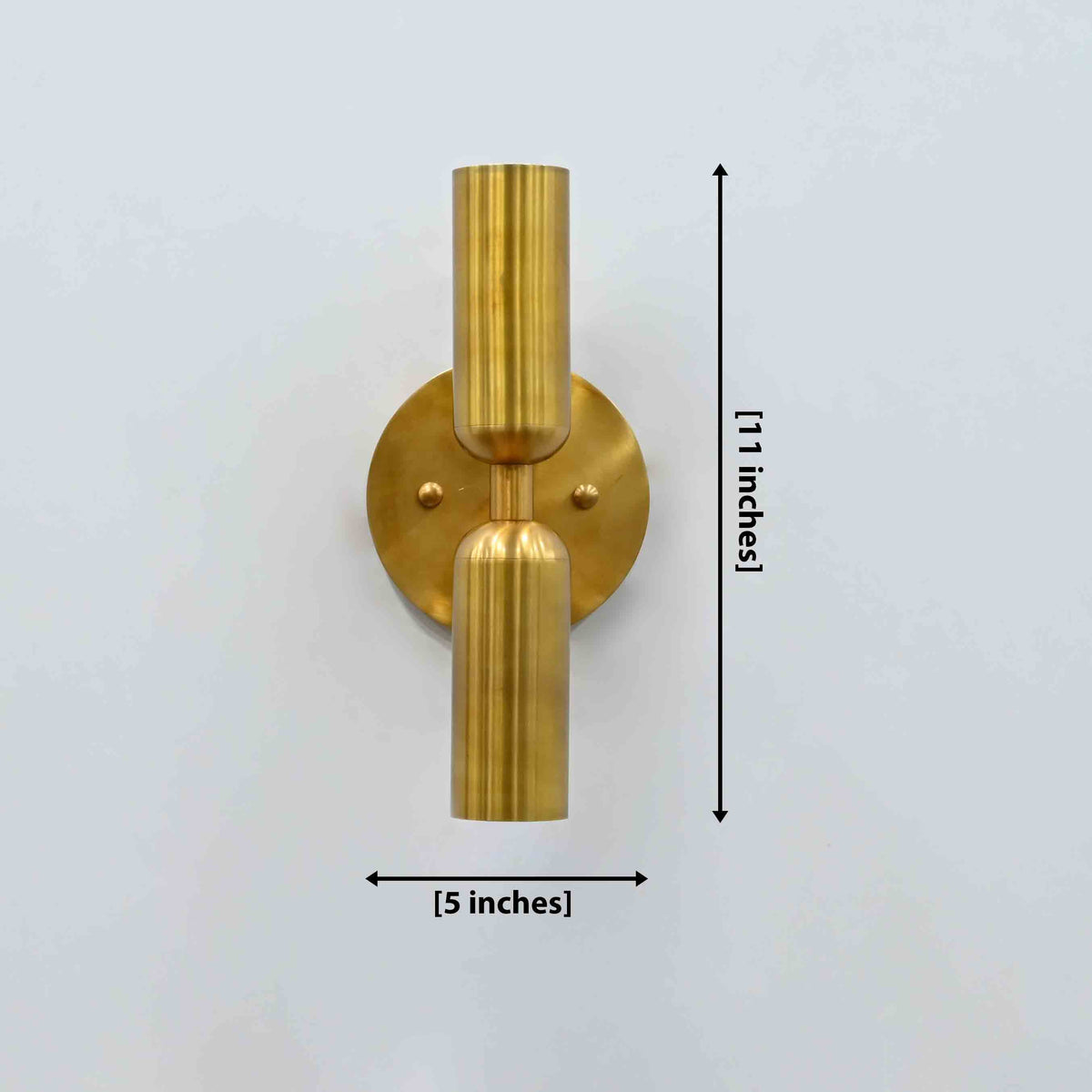 Munich cylindrical dual shade brass wall sconce with two vertical lights, round canopy, and warm up down wall glow