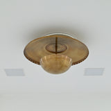 Mid century inspired brass ceiling light with low-profile design, perforated disc and decorative lower bowl