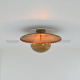 Statement brass ceiling light with perforated detailing and warm patina finish for modern interiors