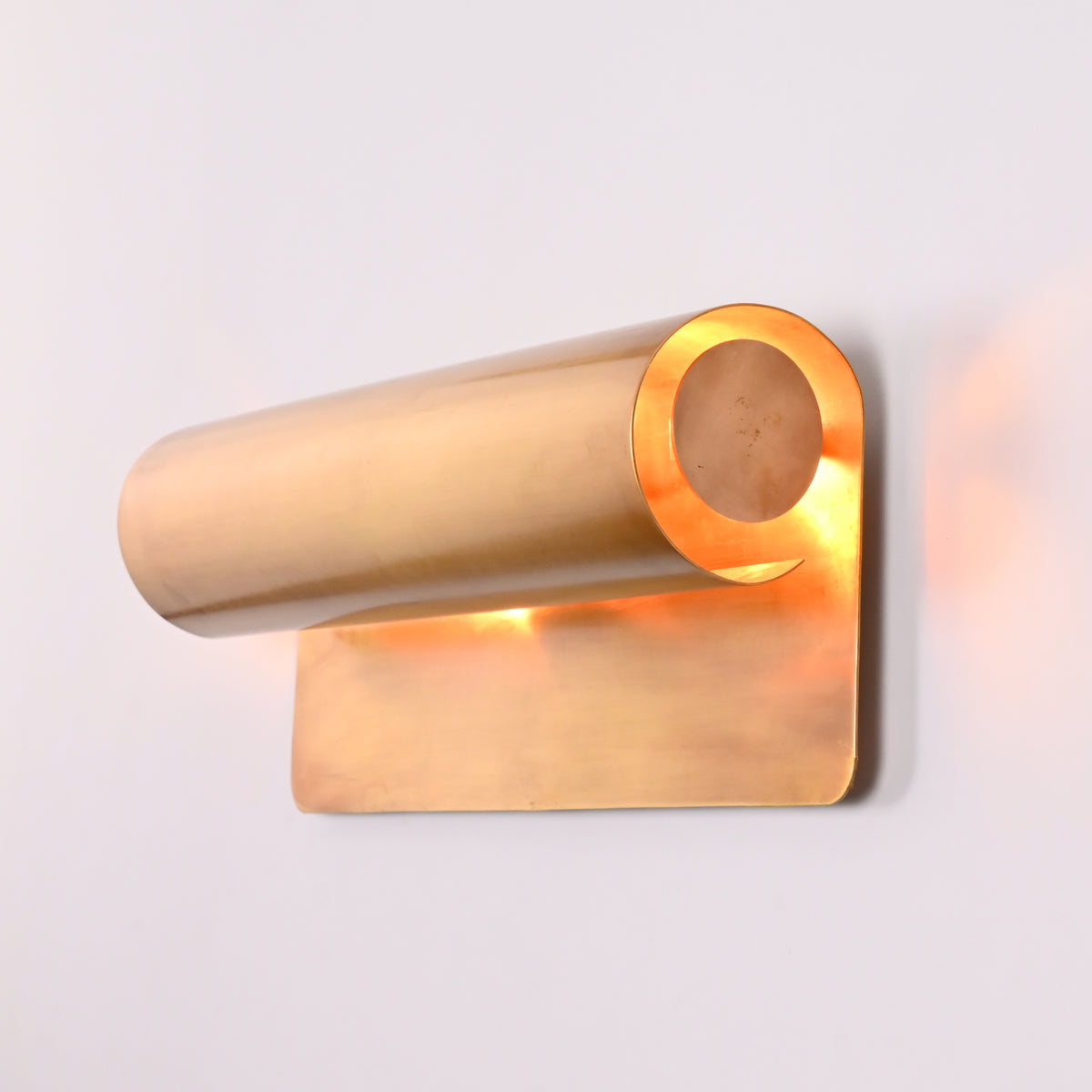 Brass wall sconce styled in office and library interior with soft architectural wall lighting
