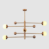 Opal glass globe chandelier close view showing warm glow, brass cup details, and decorative ball accents