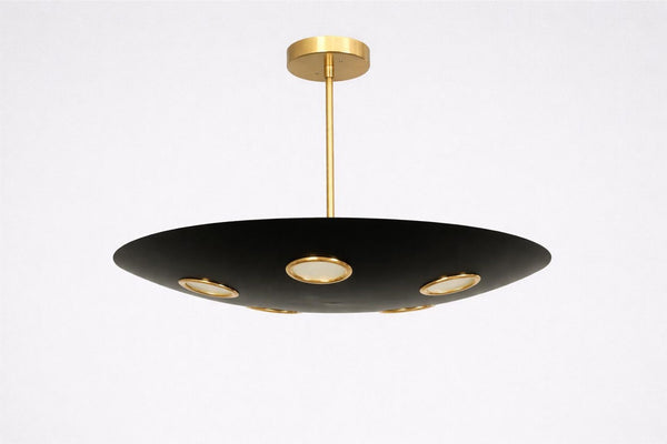 Orbit disc brass chandelier in matte black with gold accents, featuring five recessed lights for warm ambient ceiling illumination.