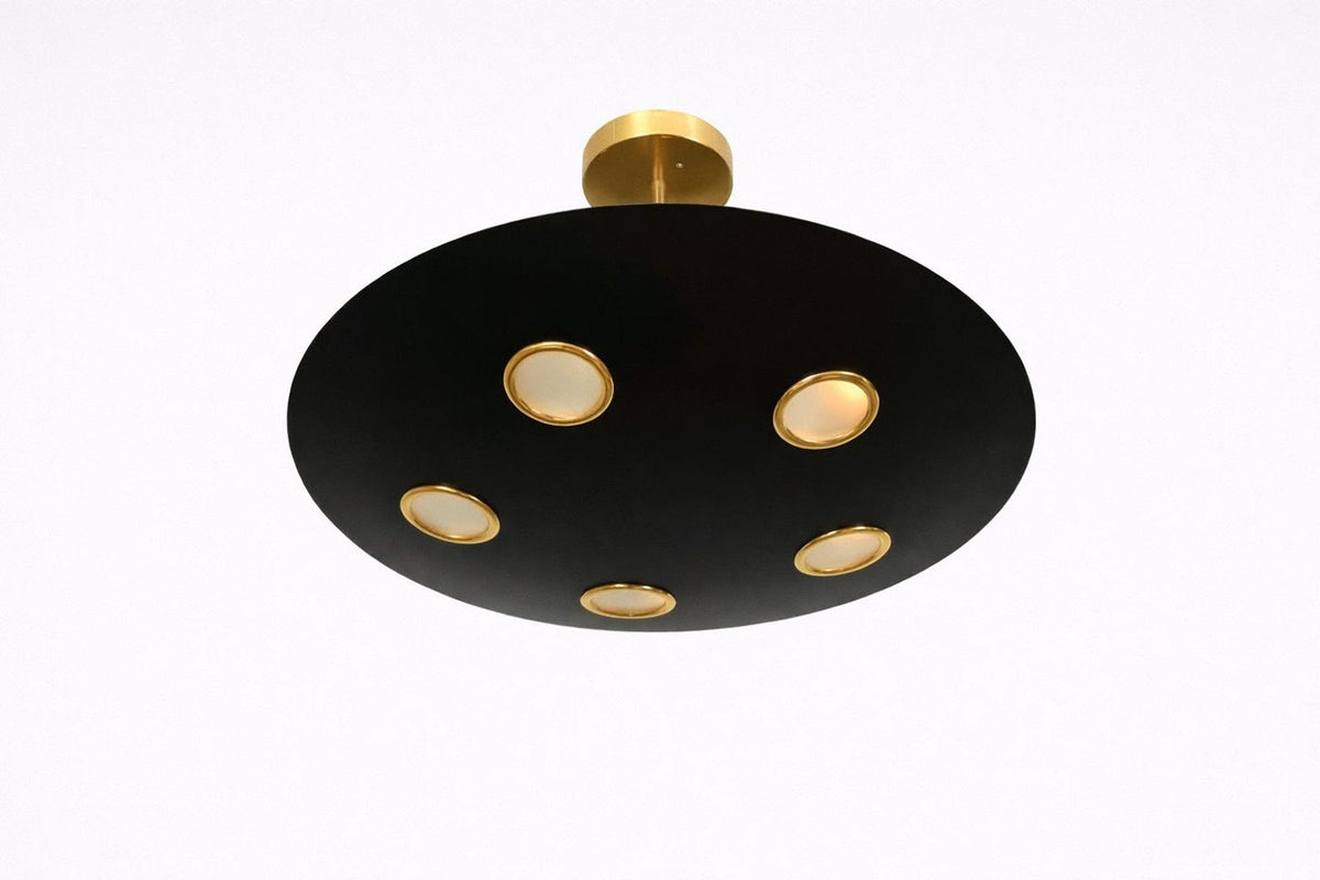 Bottom perspective of black brass disc chandelier displaying five evenly spaced recessed light points with warm glow.