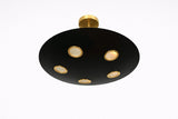 Bottom perspective of black brass disc chandelier displaying five evenly spaced recessed light points with warm glow.