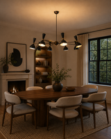 Orion 16 light black and brass chandelier styled above a modern dining room table