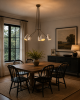 Orion 5 Light Multi-Arm Cone Chandelier 34 Inch Model 62069 installed above a modern dining table, showcasing warm ambient illumination and a Mid-Century Modern design.