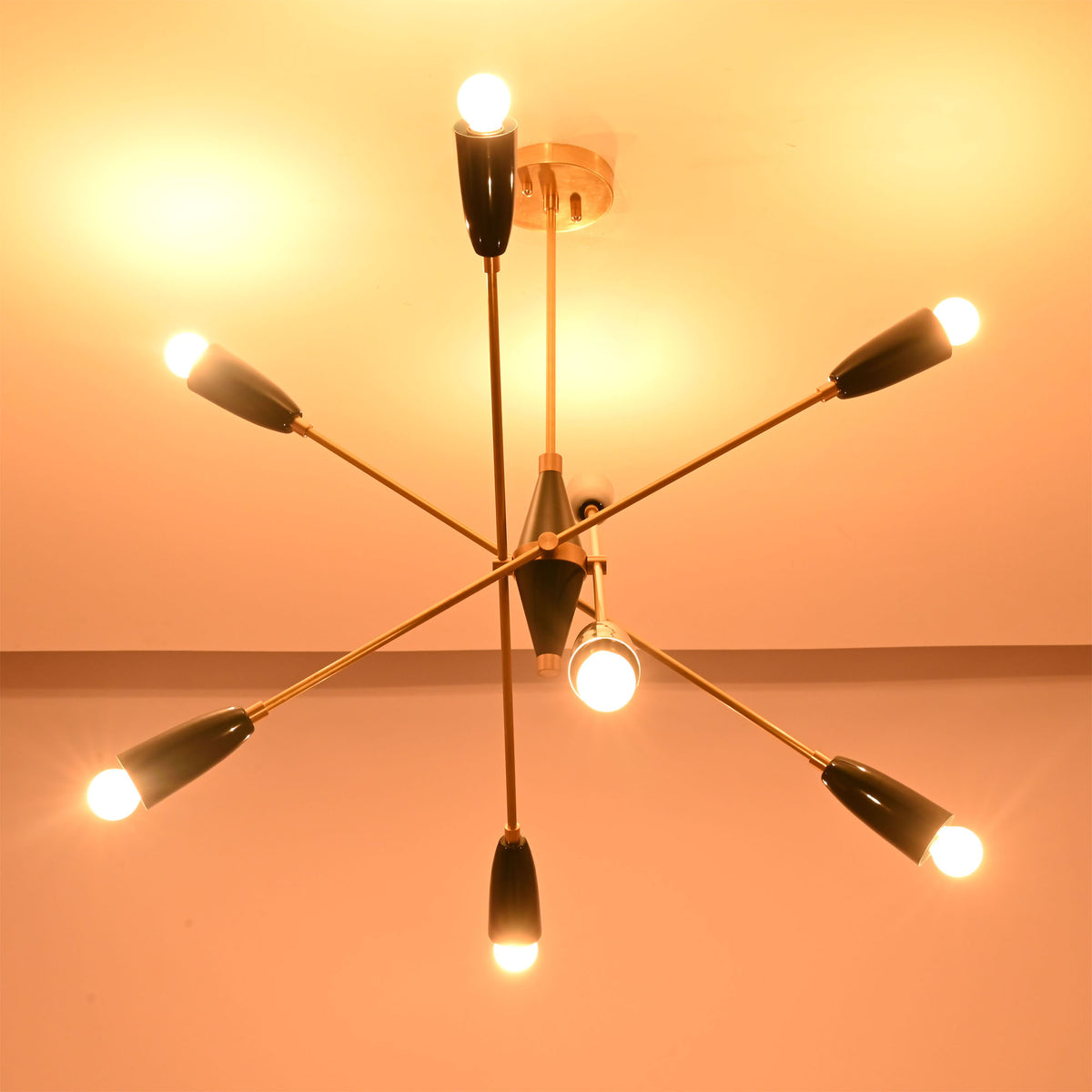 Perspective view of the Oslo Mid-Century Modern Sputnik Chandelier with geometric starburst arms and glowing bulbs