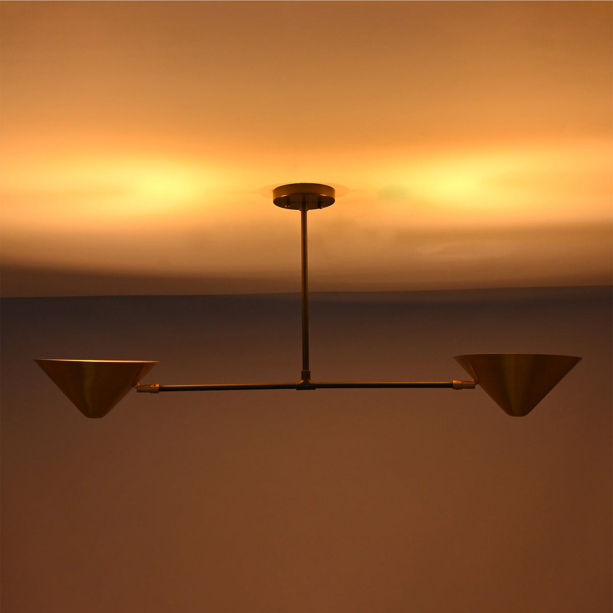 Oslo Modern Double Cone Linear Chandelier creating warm indirect ceiling illumination
