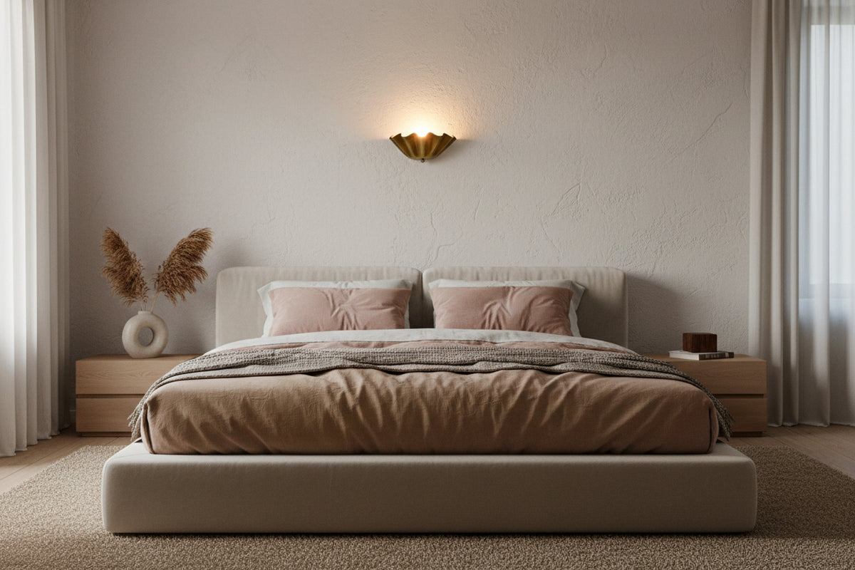 Palermo brass sconce shown lit with warm golden glow reflecting beautifully on the wall