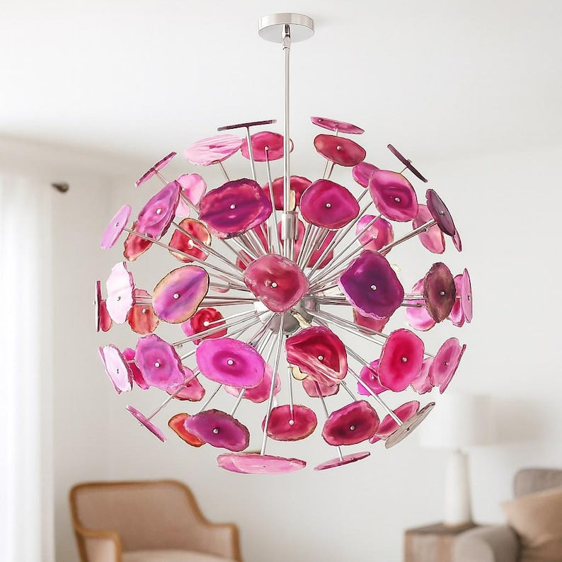 Pink agate stone chandelier with spherical design and polished metal frame creating a bold sculptural lighting statement