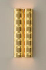 Polished brass modern wall sconce with perforated metal shade and warm ambient lighting