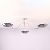 Close detail of polished chrome brass bowl shades on a modern semi flush mount ceiling light.