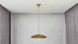 Solid brass pendant light video highlighting raw brass aesthetic, natural surface character, spare glass globe, and ceiling installation details