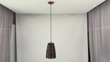 Video showing four ribbed blue and copper pendant lights installed above a dining table with black cords, copper canopies, warm downward glow, and luxury interior styling