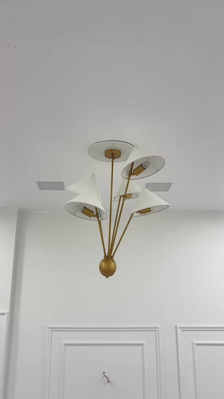 Mid century inspired brass chandelier with five fabric shades and asymmetrical multi-arm ceiling design
