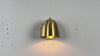Close-up video of brass dome wall light highlighting rounded shade, backplate, and soft glowing effect.