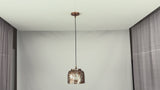 Video of Cora whitewashed copper drum pendant light showing warm glow, textured shade detail, black cord, and kitchen island installation