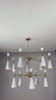 Brass Leaf Studio Celeste 12-light two-tier cone chandelier video showing white enamel painted shades, brushed brass frame, warm illumination, and luxury ceiling lighting design